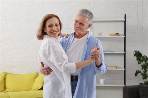 Happy Senior Couple Dancing In Living Room Stock Photo Image Of Love