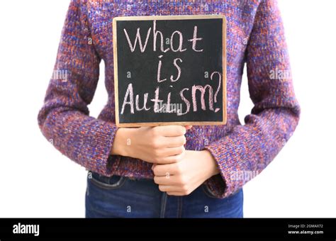Woman Holding Chalkboard With Phrase What Is Autism On Light
