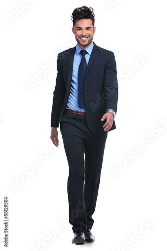 Smiling Business Man Walking Forward Towards The Camera Stock Photo