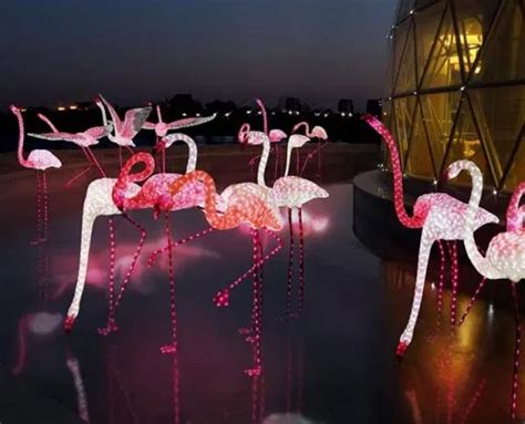 Some Pink Flamingos Are Lit Up In The Dark
