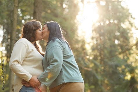 Two Overweight Lesbians Kissing Each Other During Their Walk In The Forest Stock Photo Adobe Stock