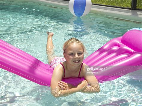 Young Girl On An Airbed In A Swimming Pool High Res Stock Photo Getty