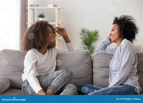 Happy African American Mother And Teen Daughter Chatting At Home Stock