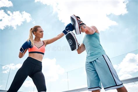 Confident Woman Is Hitting Man During Training Outdoors Stock Image