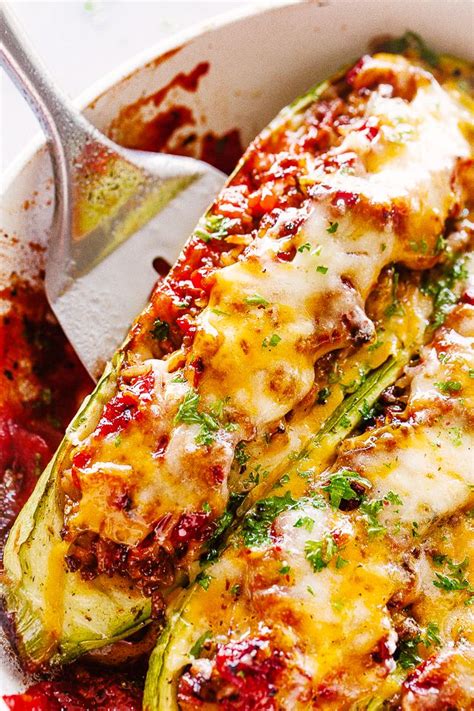 Easy keto zucchini boats recipe. Stuffed Zucchini Boats - Baked tender zucchini stuffed with a rich meat sauce and topped with a ...