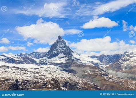 Scenic View On Snowy Matterhorn Mountain Peak In Sunny Day With Blue