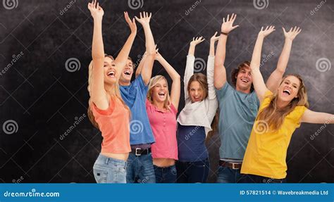 Composite Image Of A Jumping Happy Group Cheering Stock Photo Image