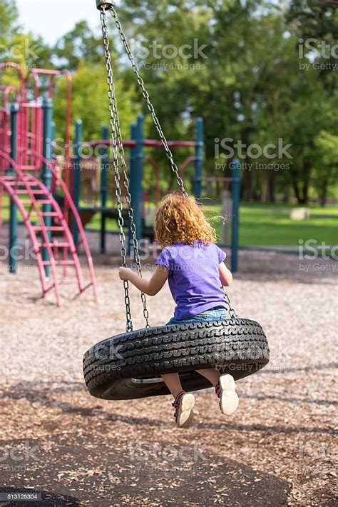 Girl On Tire Swing At Playground Stock Photo Download Image Now