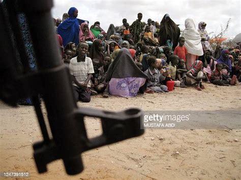 Somali Displaced People Wait For A Food Aid Distribution At A Camp In
