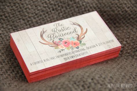 The Business Card Is Decorated With Antlers And Floral Designs On Its