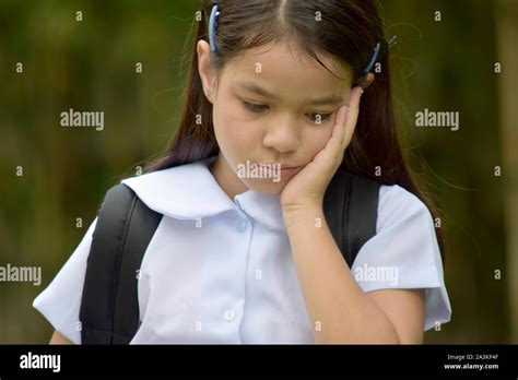 Young Filipina Female Student And Sadness With Books Stock Photo Alamy