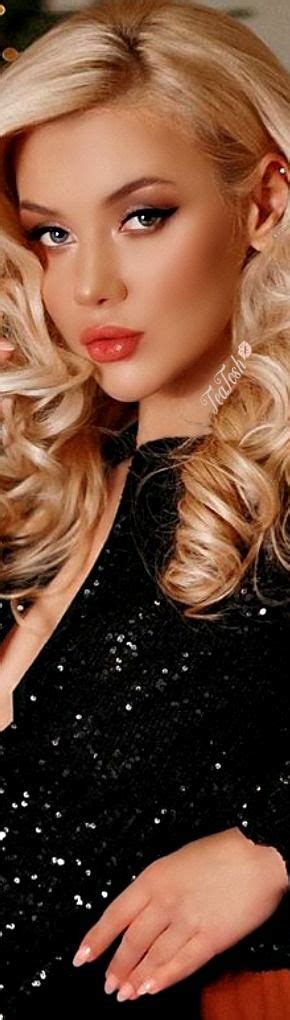 A Woman With Long Blonde Hair Wearing A Black Dress