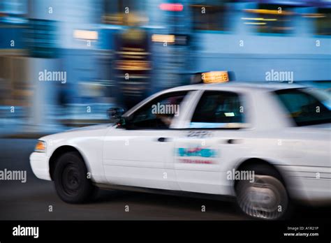 Illinois Chicago White Taxi Cab At Night On City Streetblurred Motion