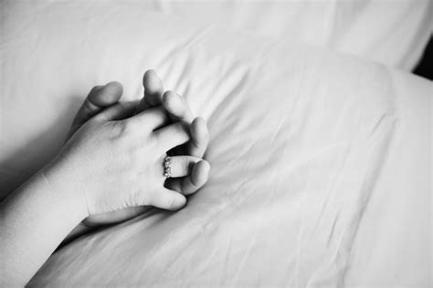 Free Photo Couple Holding Hands On The Bed