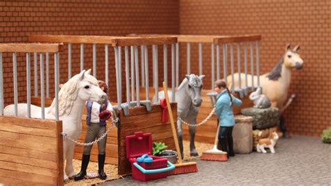 Several Toy Horses Are Standing In Their Stalls
