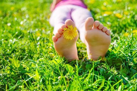 Premium Photo Child Feet On The Grass