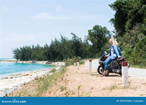 Woman Riding Motorcycle Along The Sea On The Road To Hai Van Pass