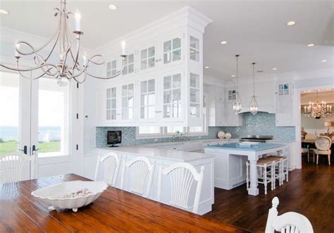 This cabinet can be accessed from both the front and the back of the cabinet. see through design open plan white kitchen | White kitchen ...
