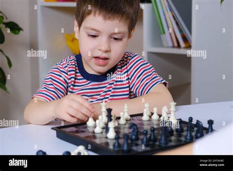 A Preschool Boy Plays Chess Board Games For Children Stock Photo Alamy