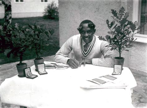 Three Boxes Containing Gold Medals Sit At The Base Of The Pots Of Three