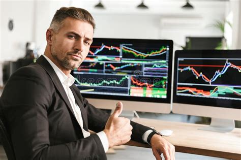 Image Of Confident Businessman Working In Office On Computer With