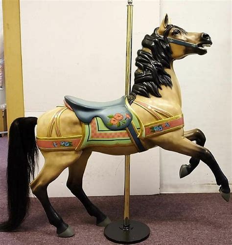 A Carousel Horse Is Standing On Its Hind Legs And Has A Black Mane