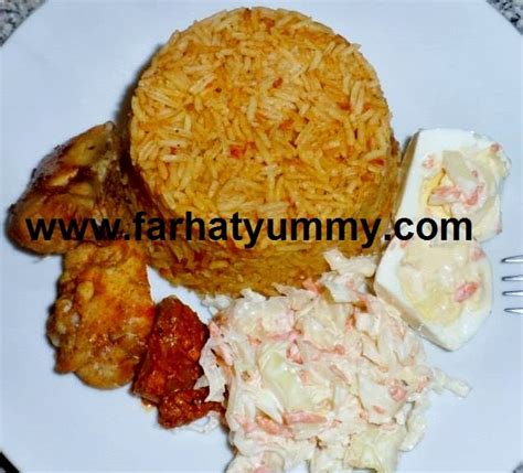 The rice is cooked in a flavorful tomato and pepper purée; Homemade Jollof rice with chicken, coleslaw and hard Boiled Eggs - Farhat Yummy