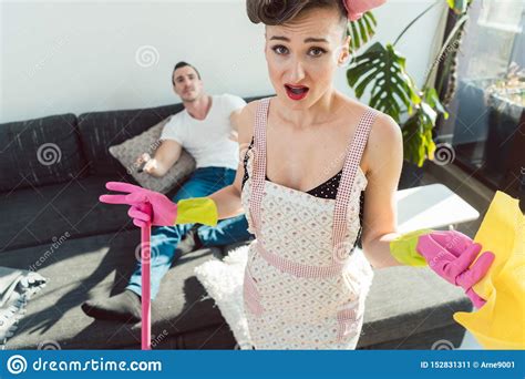 wife is mad at her lazy husband who is not helping with chores stock image image of housework