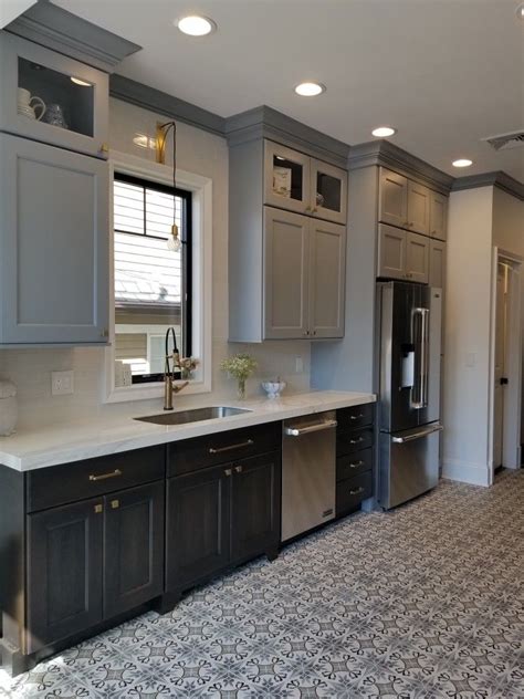 Dark stained wood cabinetry mixed with white painted cabinets can be a strong contrast and give your kitchen a bold and interesting look. Blue cabinets and wood stained lower cabinets. Custom kitchen by Jaclyn Isaac of DOWNTOWN ...