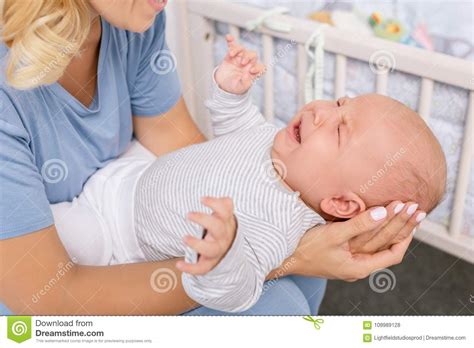 Mother Holding Crying Baby Stock Photo Image Of Cute
