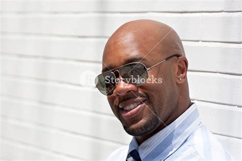 An African American Business Man Wearing His Sunglasses In The City