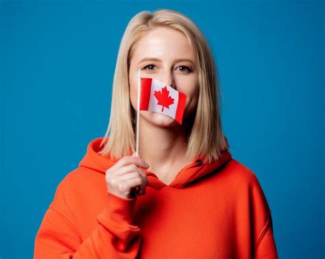 Premium Photo Girl Holds Flag Of Canada Canada Flag How To Attract Customers Workout Guide