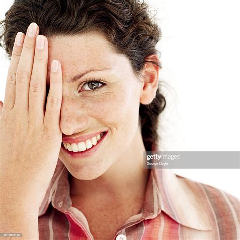 Portrait Of A Young Woman Covering Her Face With Her Hand Photo Getty