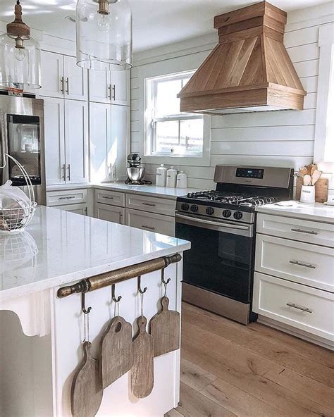 This kitchen includes all of the elements i love the most…shiplap on the walls, open shelving, modern door hardware a gorgeous range hood. Range hood cover | Farmhouse style kitchen, Kitchen hood ...