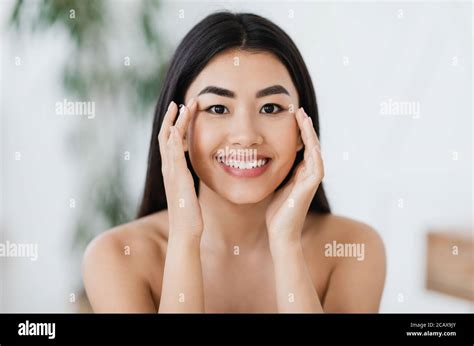 Attractive Smiling Asian Woman Rubbing Massaging Her Eye Zone Stock Photo Alamy