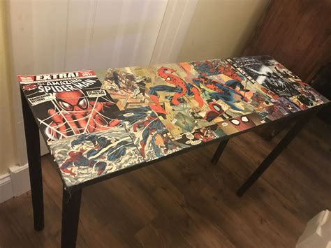 A Table Covered In Comic Books On Top Of A Wooden Floor Next To A Door