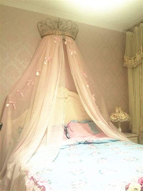 A Canopy Bed With Pink Flowers On It
