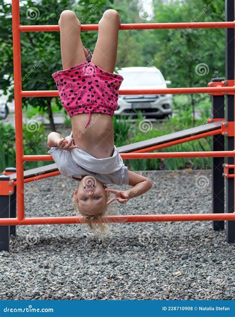 Girl Years Old Is Playing Cheerfully On The Playground Hanging