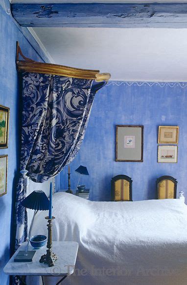 In This Bedroom A Glamorous Note Is Created By A Gilded Antique Canopy And Blue And White Floral