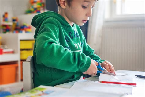 Young Boy Cutting Paper With Stock Photo Pixeltote