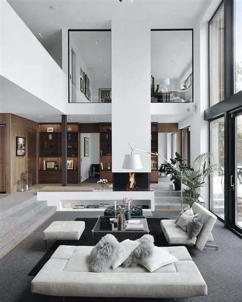 A Living Room With Couches Tables And Windows In The Wall To The Outside