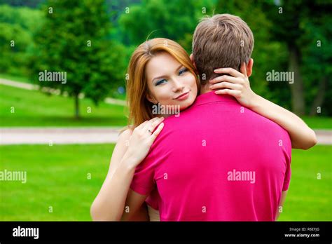 Close Up Portrait Of Attractive Girl Embracing Her Boyfriend Outdoors