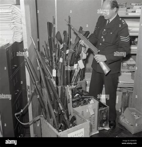 1960s Historical Male British Police Sergeant Holding A Rifle Stock