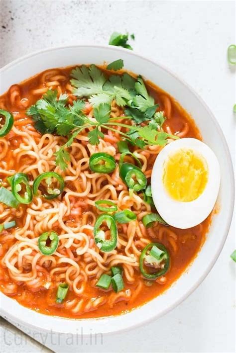 Soft Boiled Egg Placed Over A Bowl Of Spicy Sriracha Ramen Noodle Soup