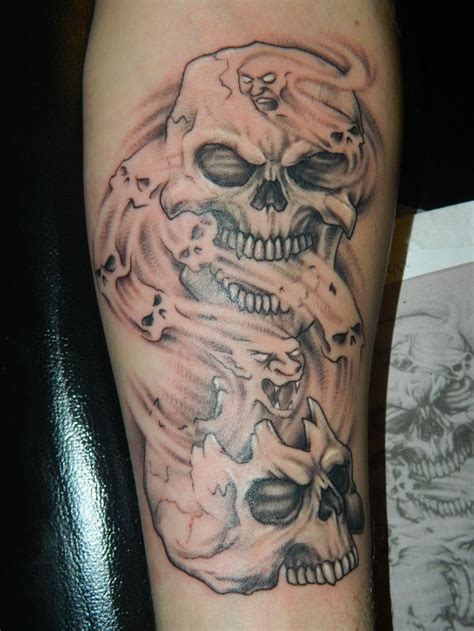 Two Skull Tattoo Wswirling Spirits On Guys Arm