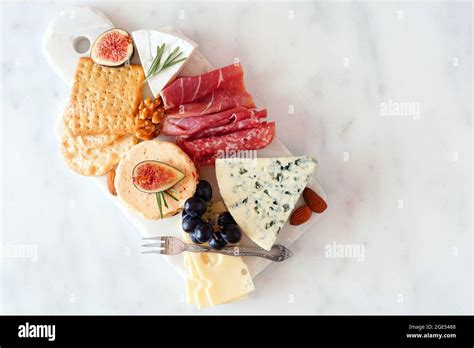 Appetizer Platter With Assorted Cheeses And Cold Cut Meats Top View On