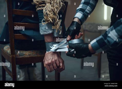 Maniac Kidnapper Taping His Female Victims Hands Stock Photo Alamy