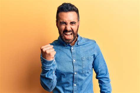 Young Hispanic Man Wearing Casual Clothes Angry And Mad Raising Fist
