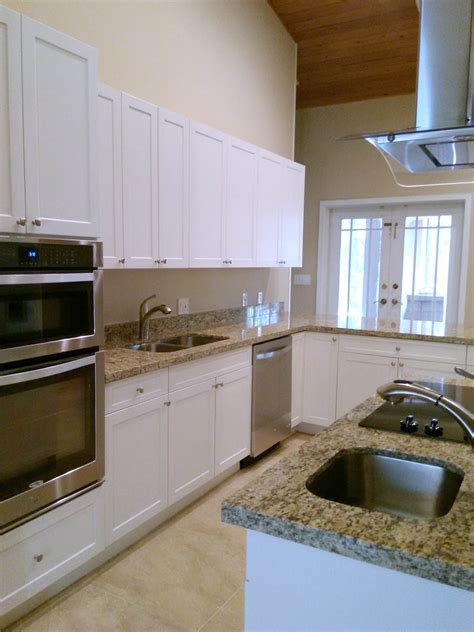 It provides the additional floor, counters and cabinet space, creating an efficient work triangle. G-Shaped Kitchen Layout with Island — Miami General Contractor