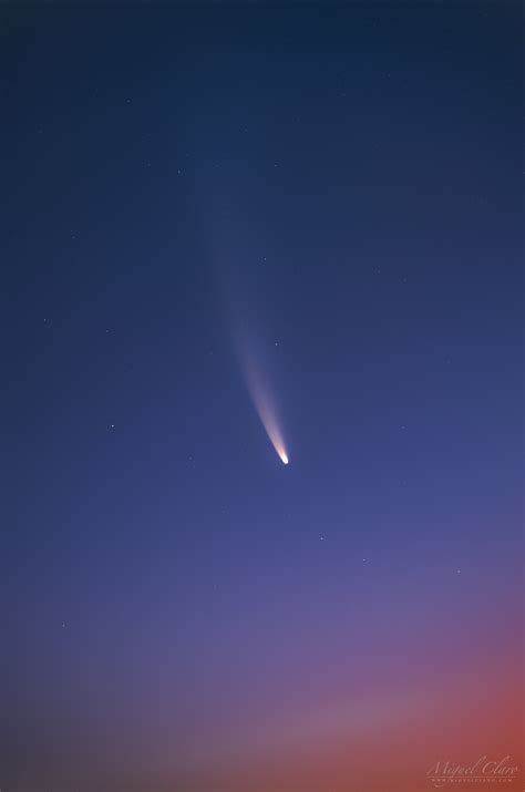 close up view of comet neowise against a colorful predawn sky astrophotography by miguel claro